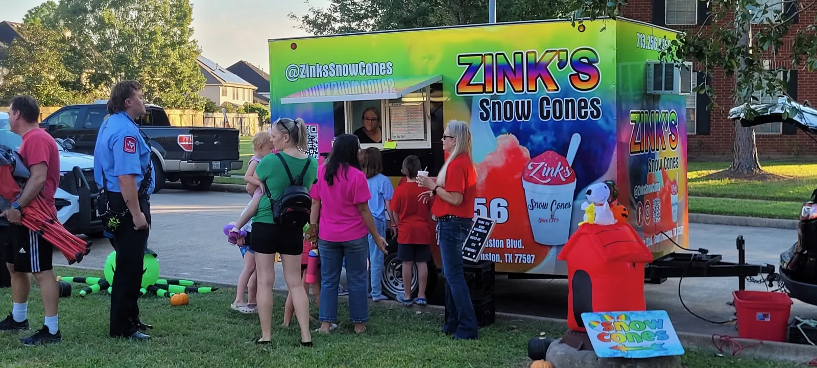 A crowd lined up at the Zink's trailer at an outdoor event